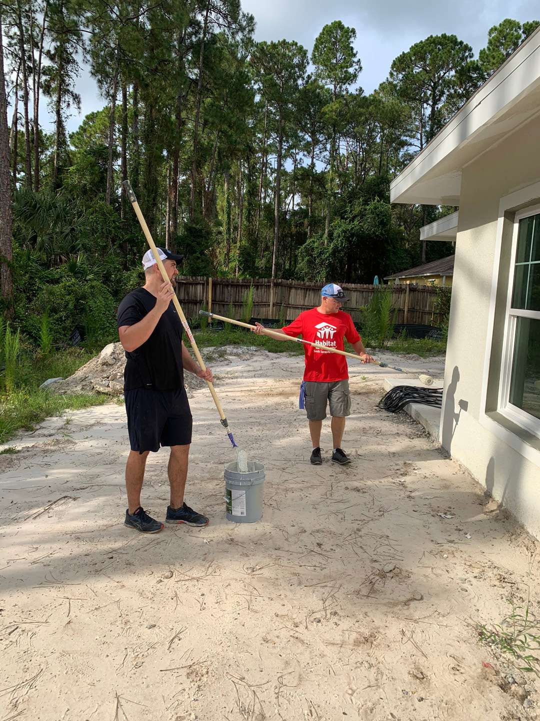 a couple of men holding a shovel