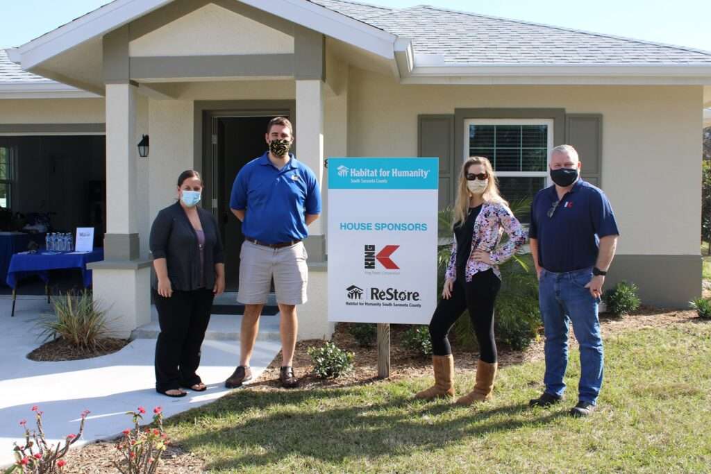 Photo of newly built Habitat for Humanity Home with Fashaw Family, Charlie, Holly, and Bill.