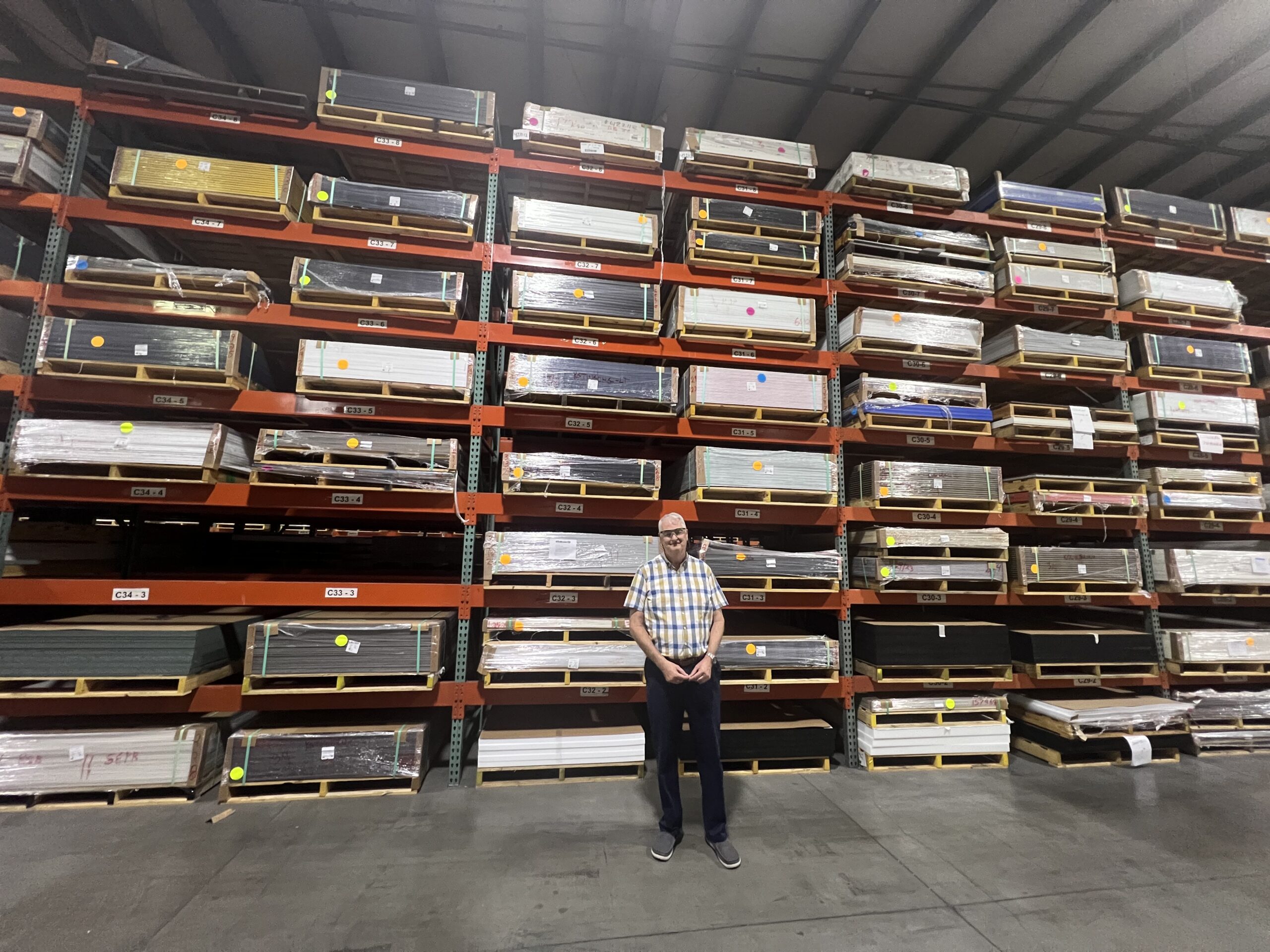 Although Jeffrey King stands at 6-feet 5-inches tall, the shelves in his warehouse tower above him. SUN PHOTO BY DANIEL FINTON